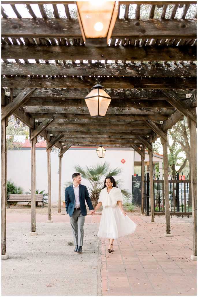 groom and bride walking down the street for a Gorgeous Downtown San Antonio Engagement Session with Monica Roberts Photography