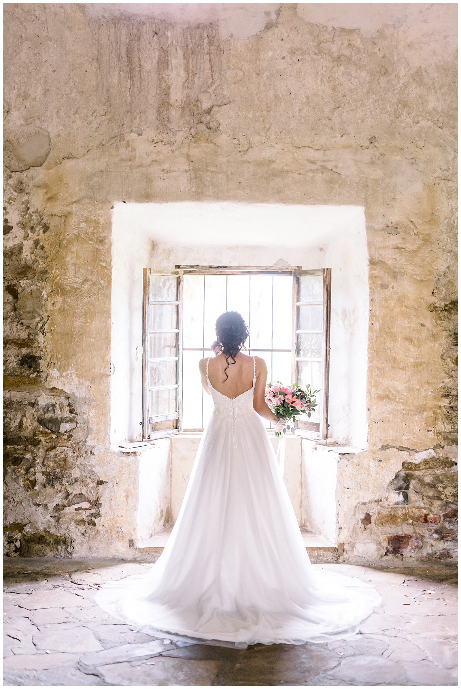 Bride standing by a window for her Spanish Missions Bridal Portraits in San Antonio, TX with Monica Roberts Photography | www.monicaroberts.com