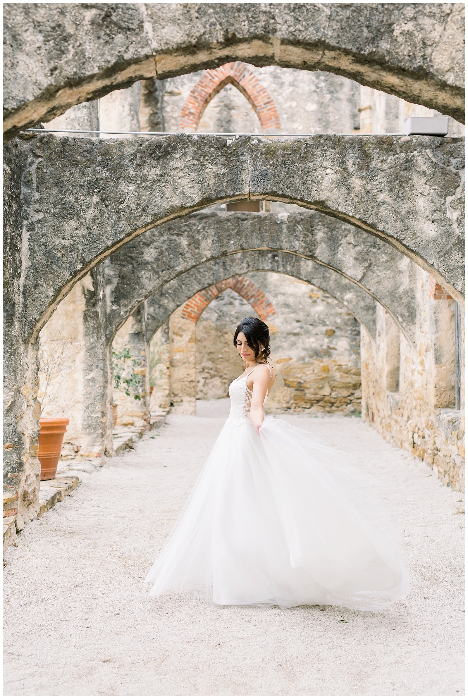 Bride twirling in her wedding dress for her Spanish Missions Bridal Portraits in San Antonio, TX with Monica Roberts Photography | www.monicaroberts.com