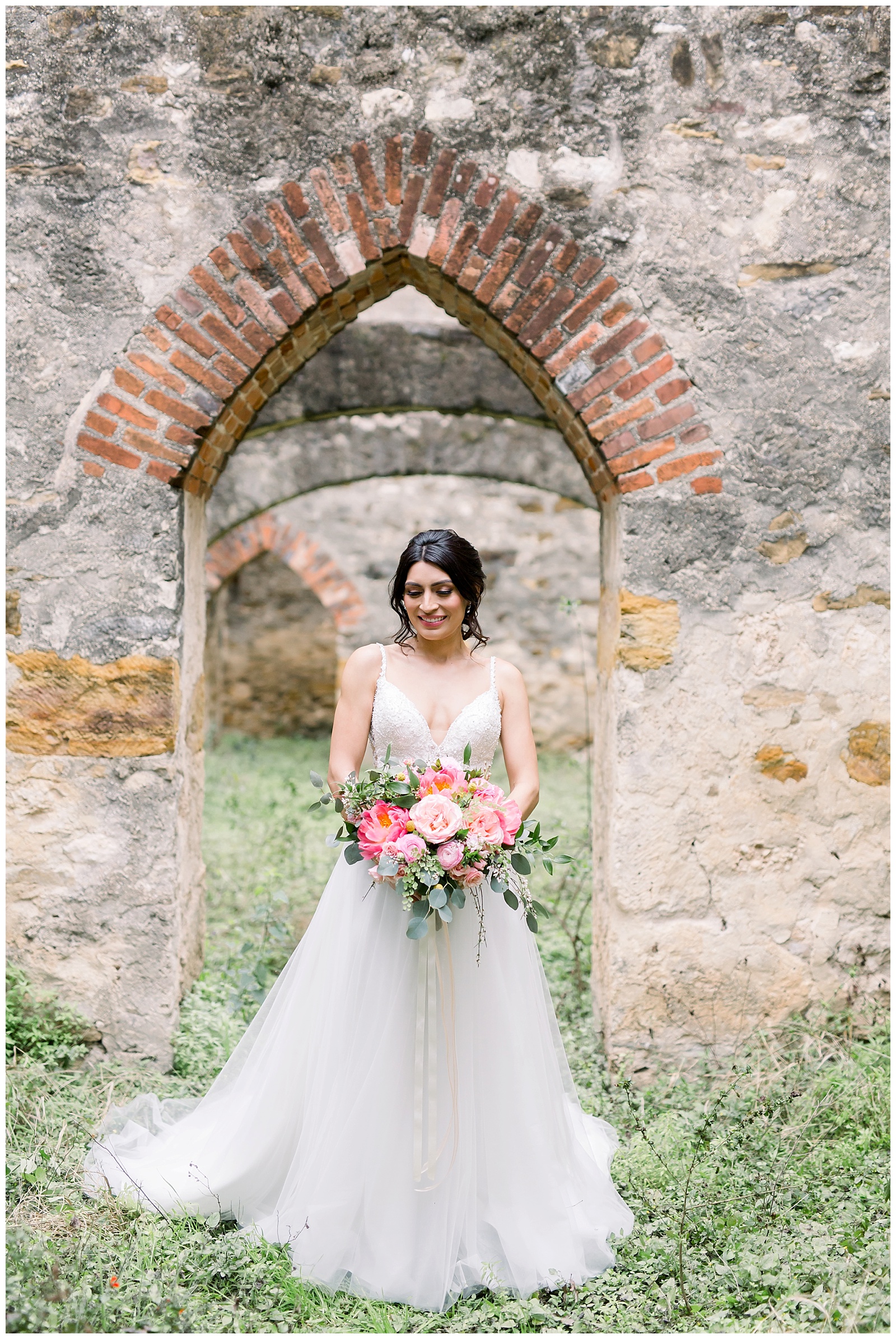 bride standing in front of an old building for her Spanish Missions Bridal Portraits in San Antonio, TX with Monica Roberts Photography | www.monicaroberts.com