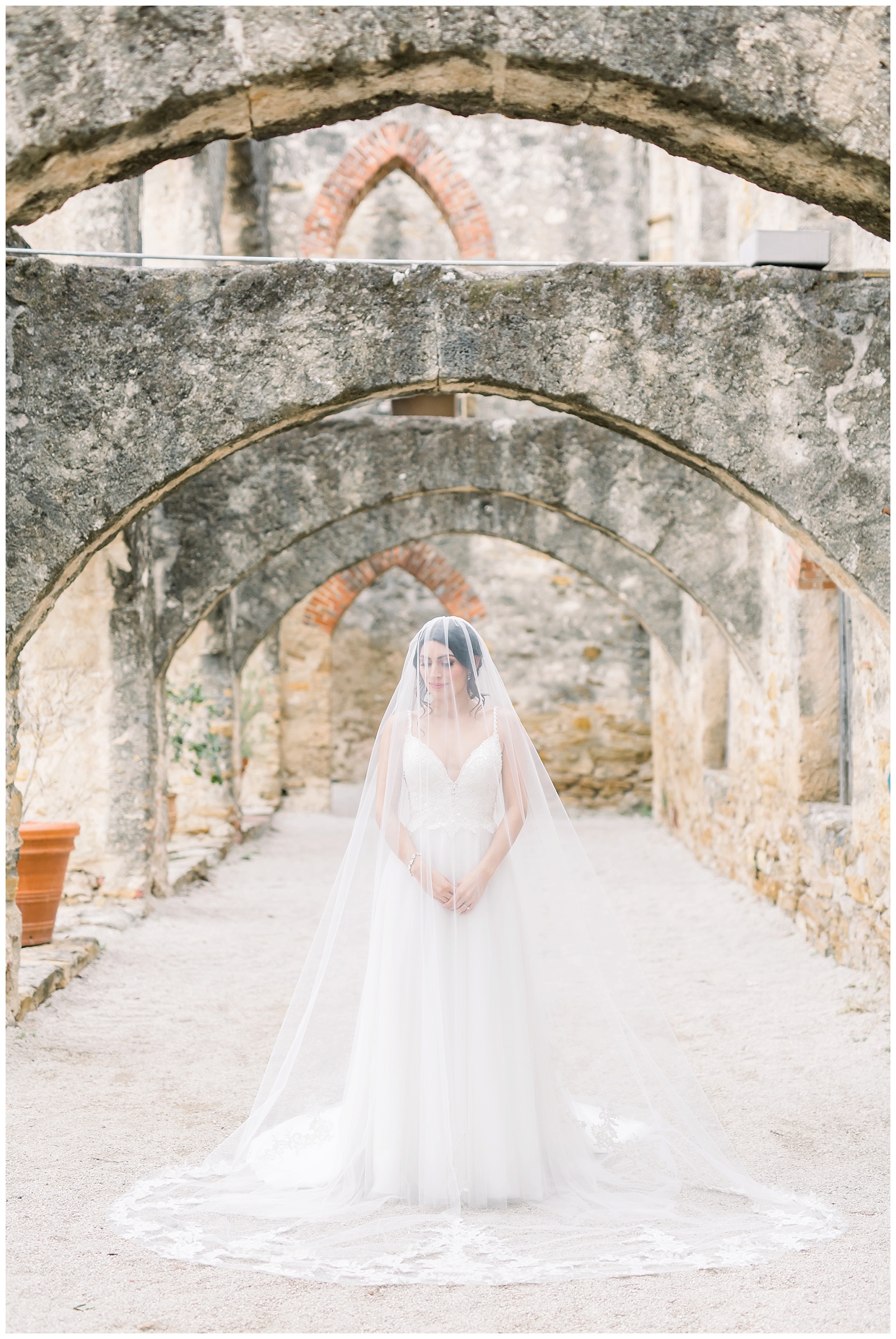 Bride standing with veil over her head for her Spanish Missions Bridal Portraits in San Antonio, TX with Monica Roberts Photography | www.monicaroberts.com