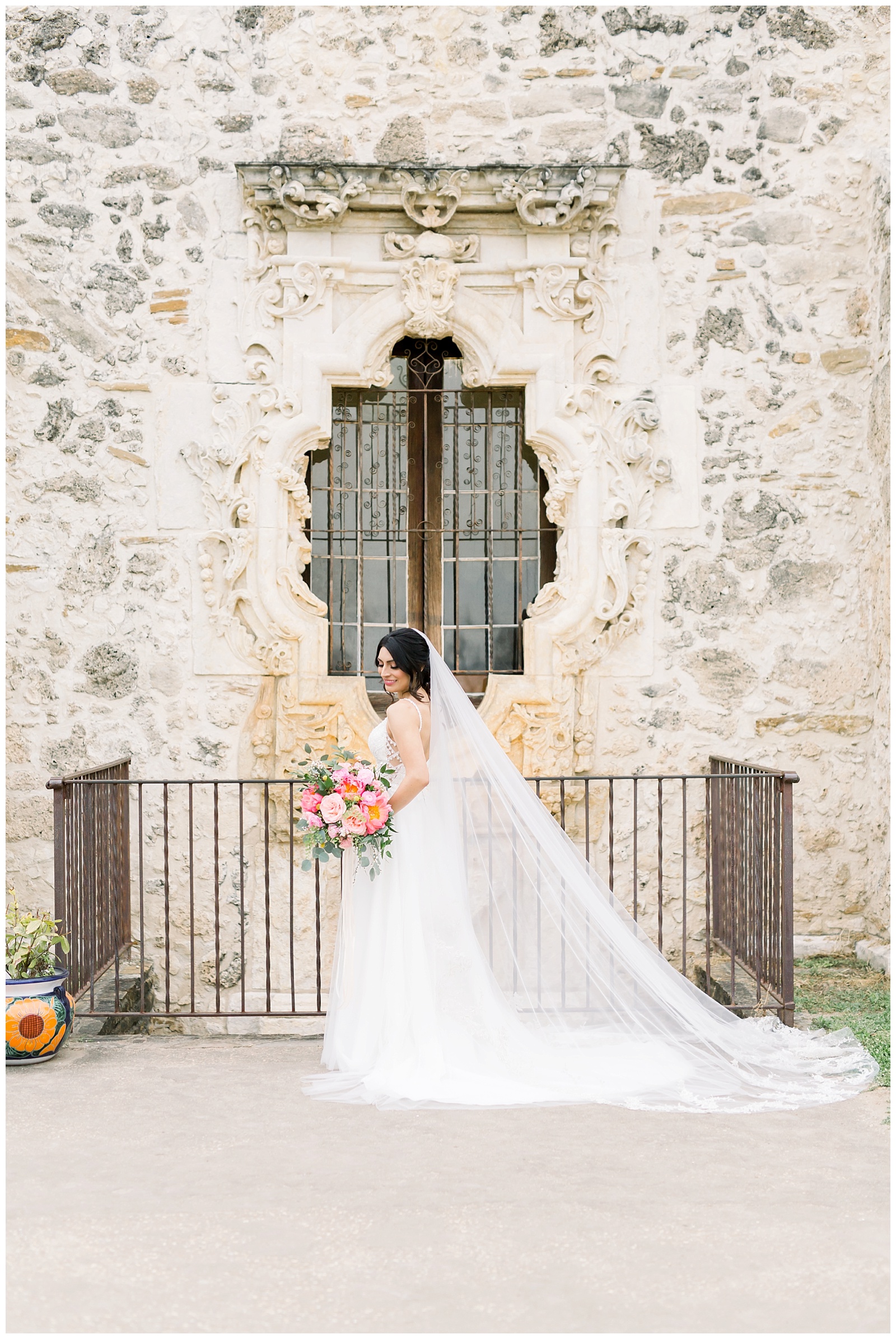 bride standing by window for her Spanish Missions Bridal Portraits in San Antonio, TX with Monica Roberts Photography | www.monicaroberts.com