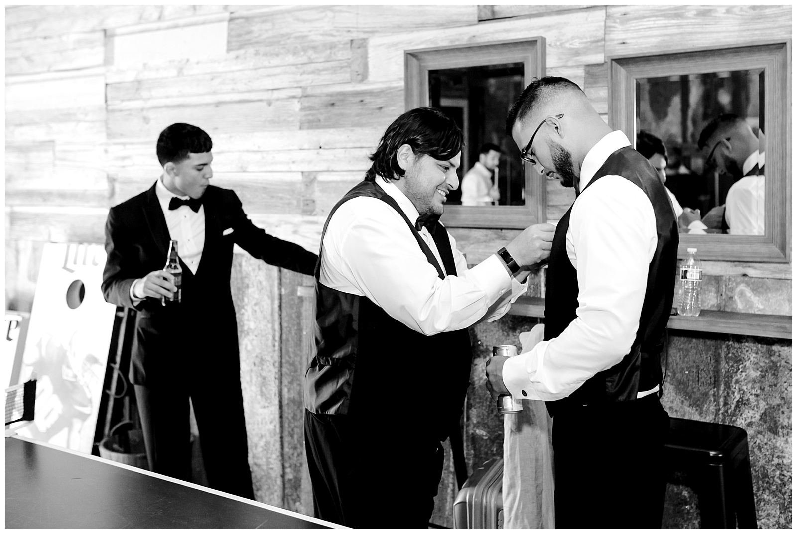 Black and white shot of groom getting ready with groomsmen for a Romantic Wedding at The Allen Farmhaus in New Braunfels, TX | San Antonio-Maui-Destination Wedding Photographer | Monica Roberts Photography | www.monicaroberts.com