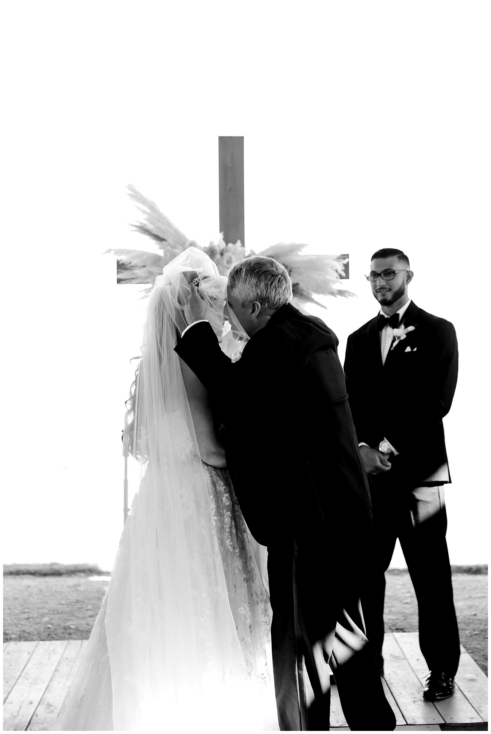 Black and white shot of bride and her father embracing at the alter as he gives her away at The Allen Farmhaus Wedding, TX by San Antonio-Maui-Destination Wedding Photographer | Monica Roberts Photography | www.monicaroberts.com