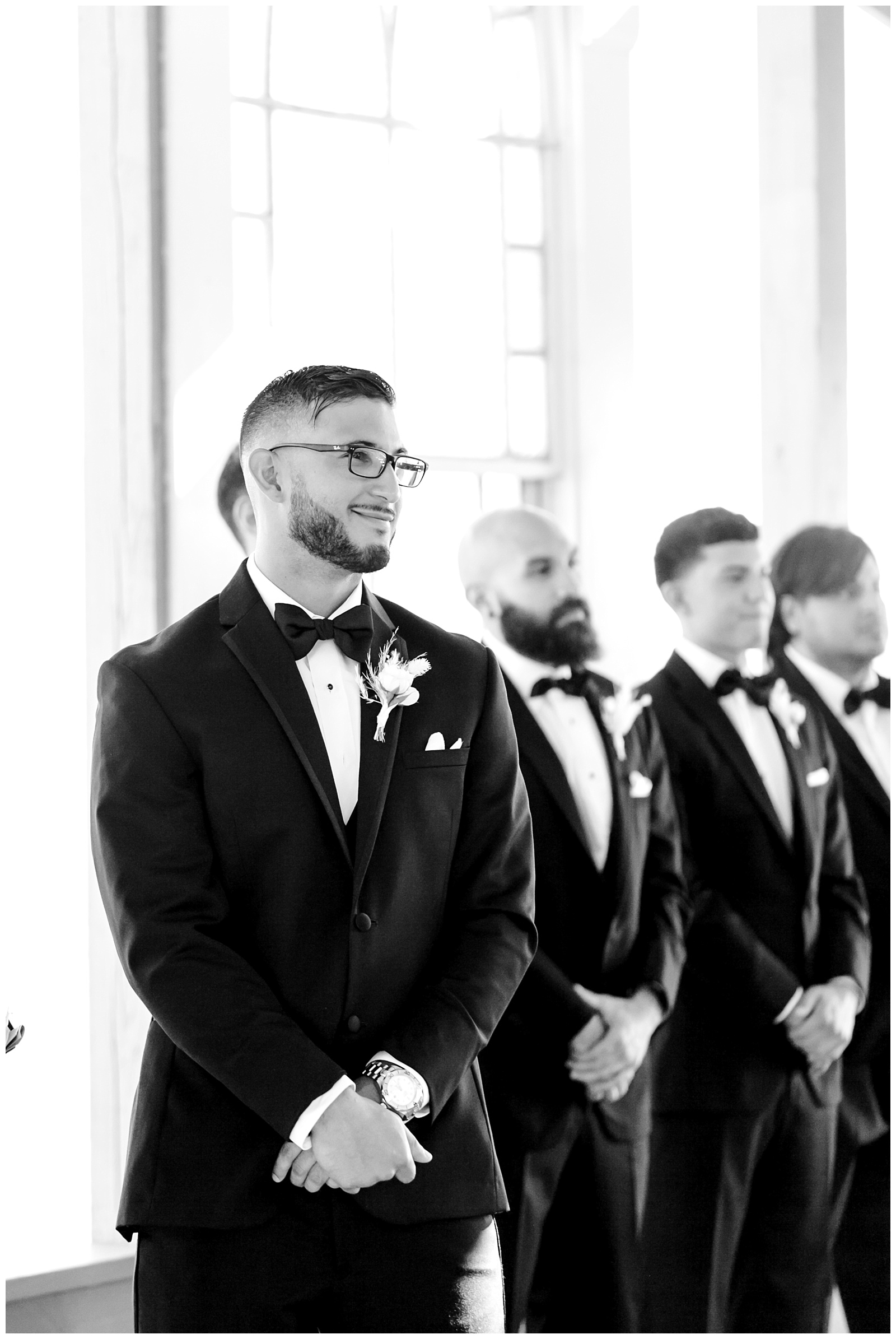 Black and white of groom and groomsman looking down the aisle at The Allen Farmhaus Wedding, TX by San Antonio-Maui-Destination Wedding Photographer | Monica Roberts Photography | www.monicaroberts.com