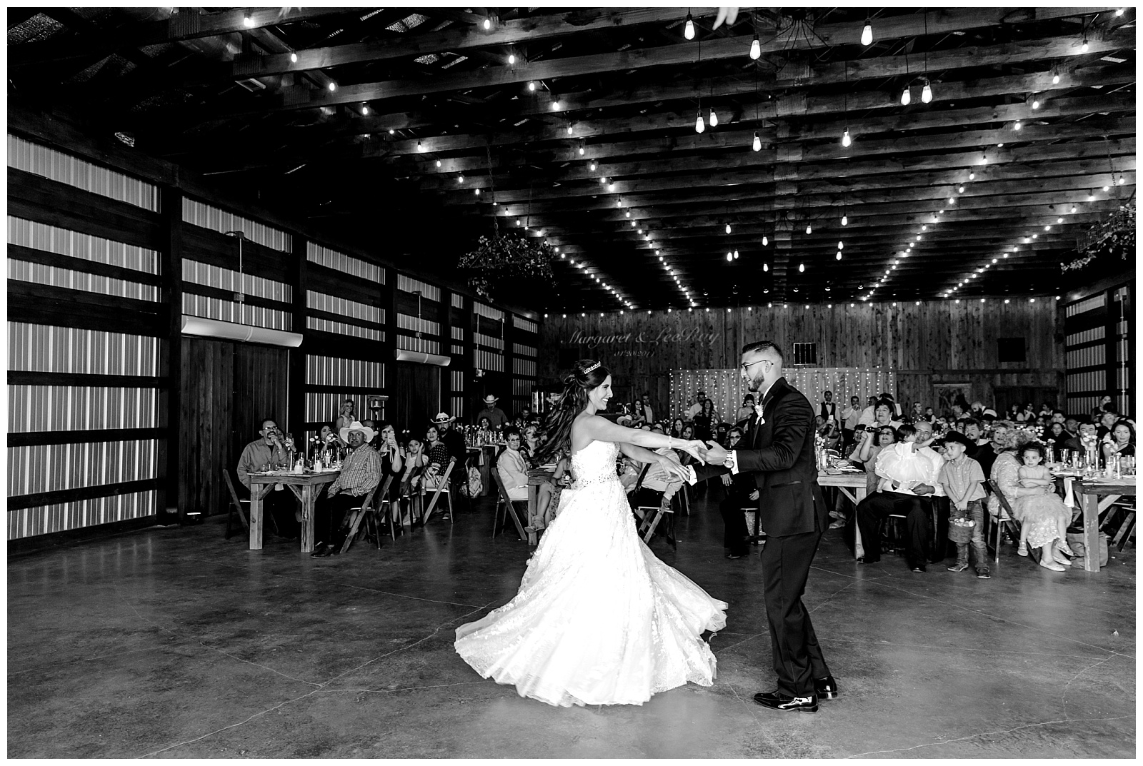 This gorgeous black and white shot captures the energy of the bride and grooms first dance at at The Allen Farmhaus Wedding, TX by San Antonio-Maui-Destination Wedding Photographer | Monica Roberts Photography | www.monicaroberts.com