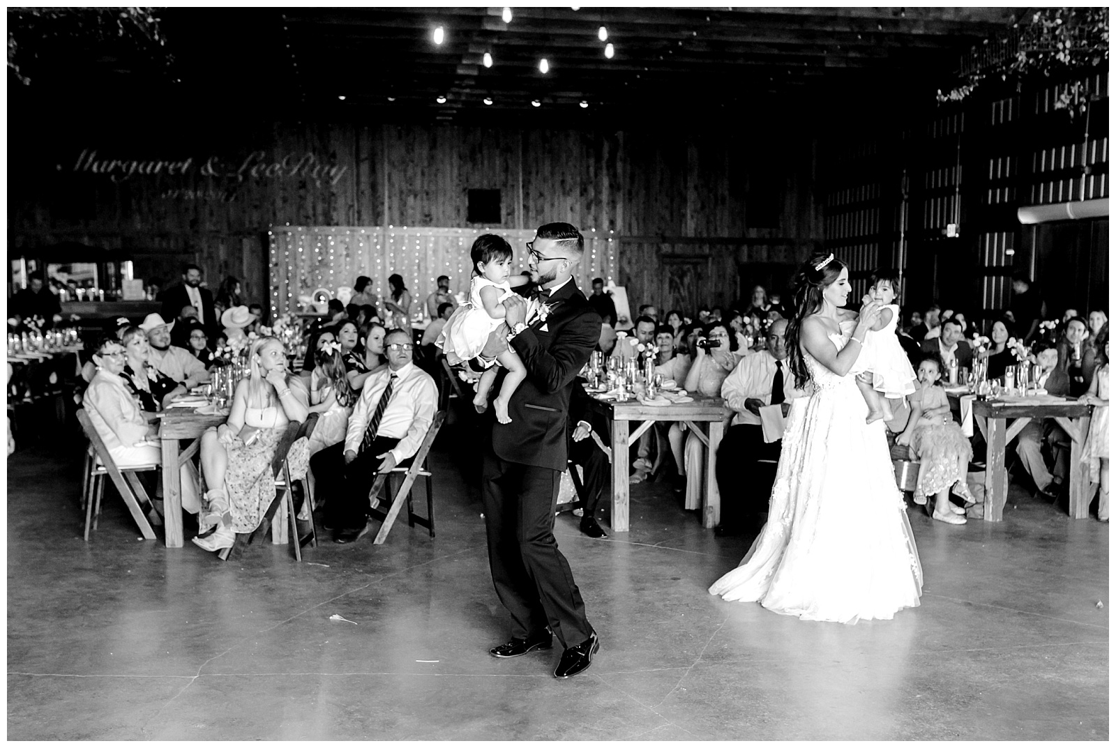 Bride and groom dance with their babies in this black & white reception shot at The Allen Farmhaus Wedding, TX by San Antonio-Maui-Destination Wedding Photographer | Monica Roberts Photography | www.monicaroberts.com