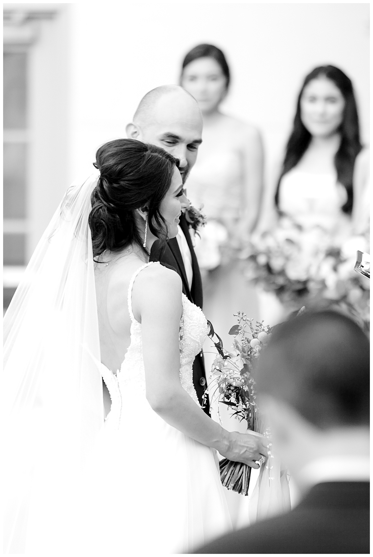 Black and white shot of bride holding hands with groom and smiling at alter at Hyatt Regency Hill Country Resort Wedding in San Antonio, TX | San Antonio Wedding photographer| Destination Wedding Photographer| Monica Roberts Photography | monicaroberts.com