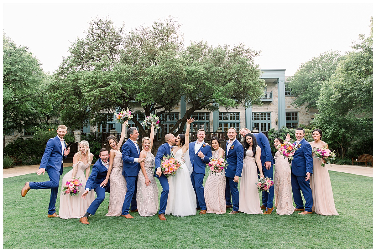 Bridal party celebrating in grassy field at Hyatt Regency Hill Country Resort Wedding in San Antonio, TX | San Antonio Wedding photographer| Destination Wedding Photographer| Monica Roberts Photography | monicaroberts.com