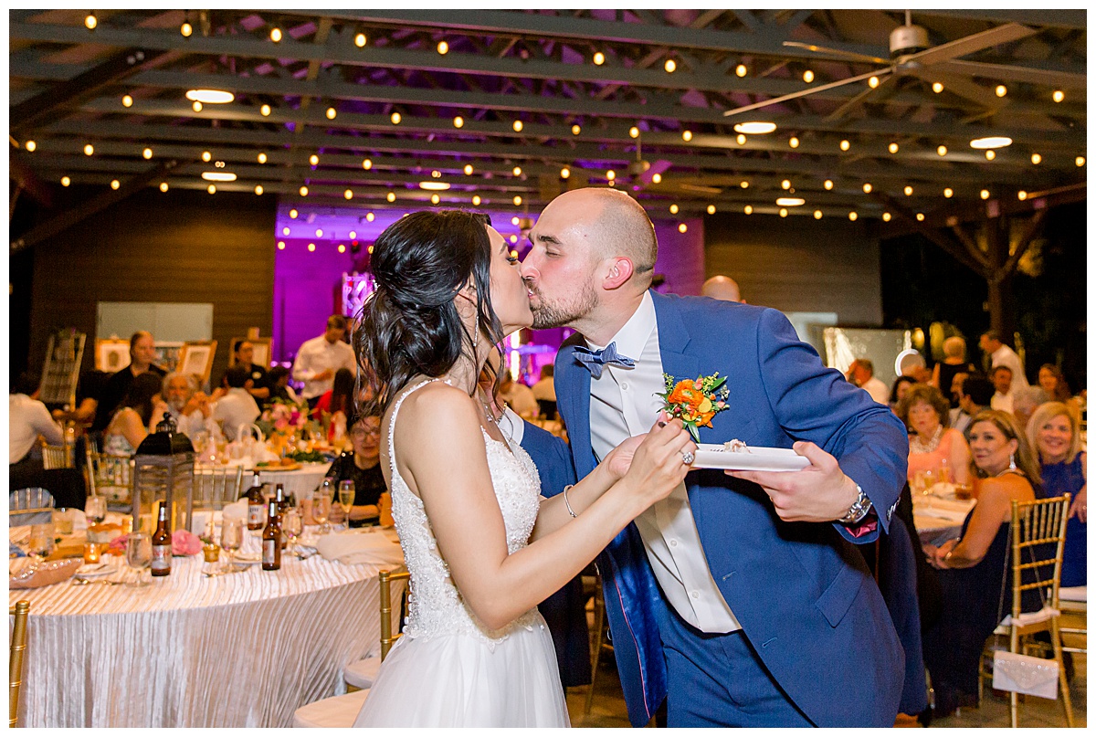 Bride and groom kiss at cake cutting at Hyatt Regency Hill Country Resort Wedding in San Antonio, TX | San Antonio Wedding photographer| Destination Wedding Photographer| Monica Roberts Photography | monicaroberts.com