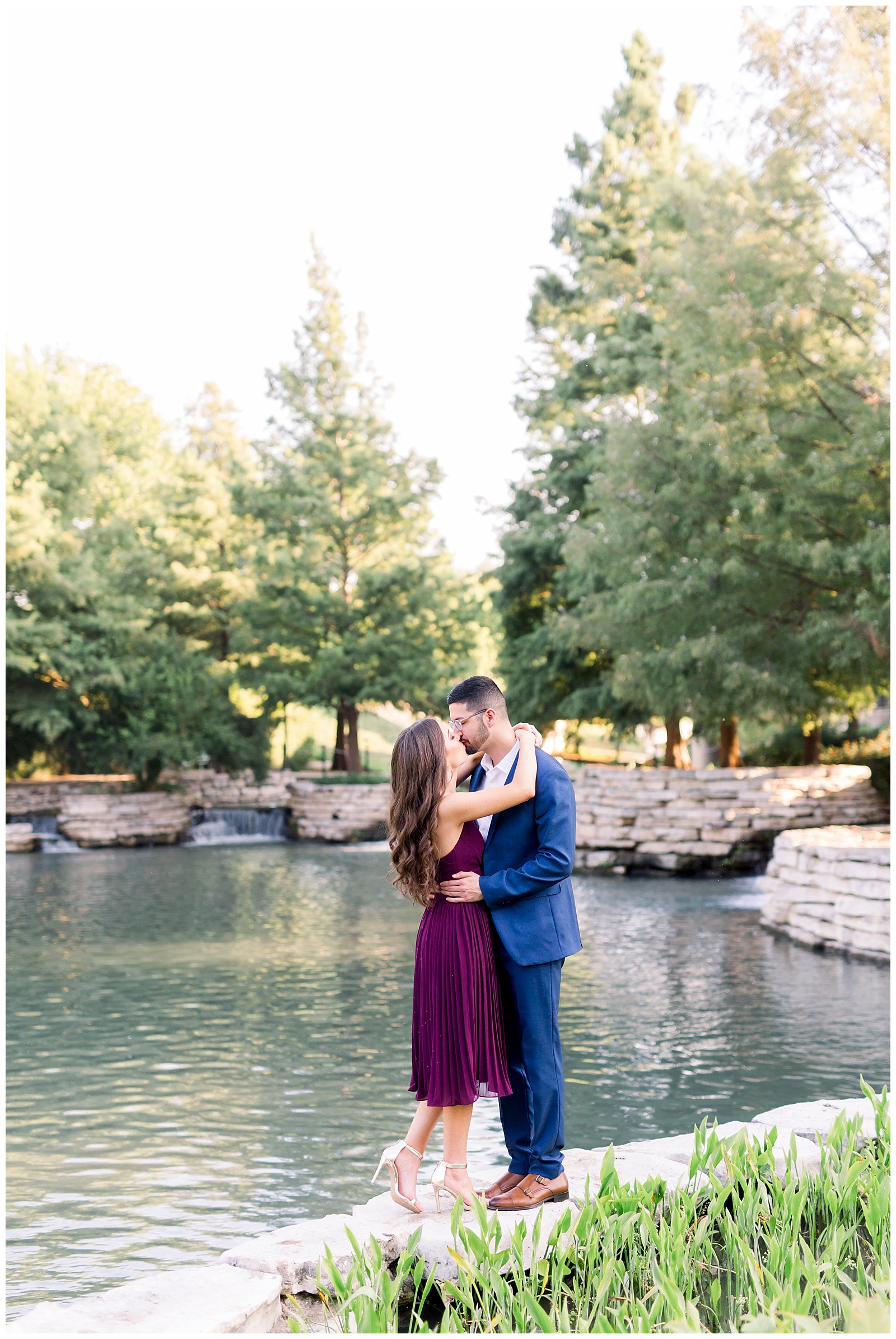 Couple kissing with the waterfall behind them at their Hotel Emma Engagement session in San Antonio, TX with Monica Roberts Photography | www.monicaroberts.com