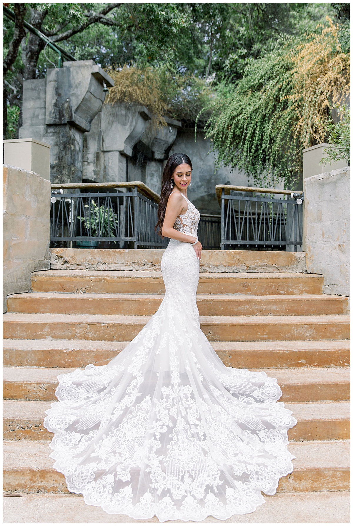 Bride looks over shoulder while standing on steps| wedding dress train down steps| villa wedding| Villa Antonia| Austin, TX wedding venue| Austin, TX wedding photographer| www.monicaroberts.com