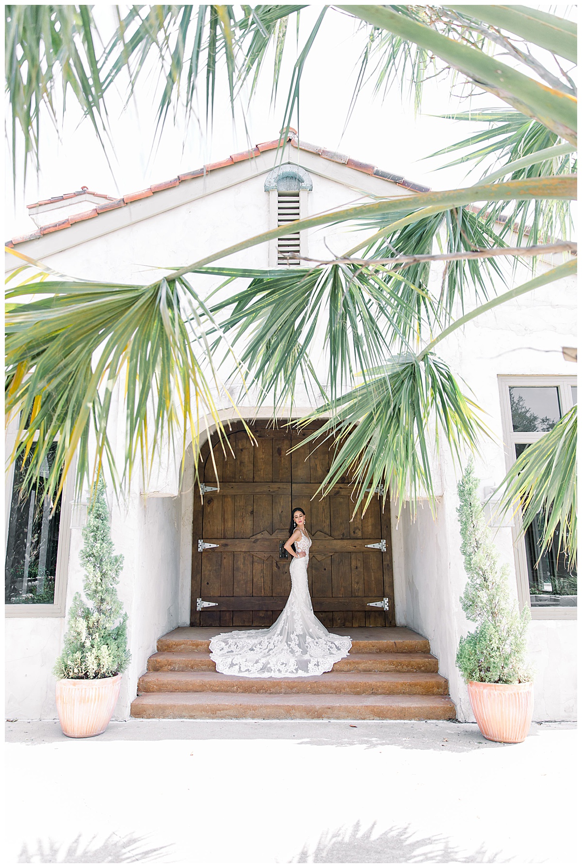 Bride standing in front of wooden doors at Villa Antonia entrance| Palm Tree bride| Lacy wedding train| Austin, TX wedding photography| www.monicaroberts.com