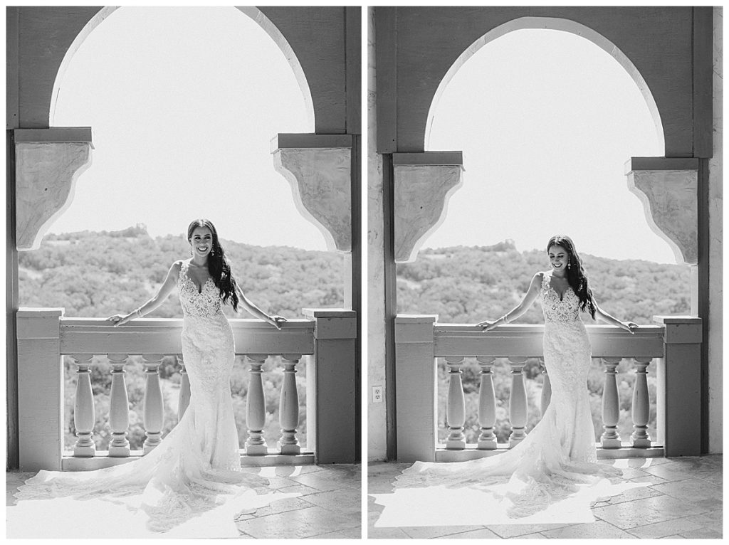 Black and white of bride smiling and leaning over terrace at Villa Antonia venue| Austin, TX wedding photographer| www.monicaroberts.com