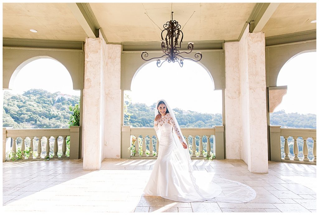 Bride holds long veil out under terrace| Villa Antonia bride| Villa bride| Austin, TX photographer| www.monicaroberts.com