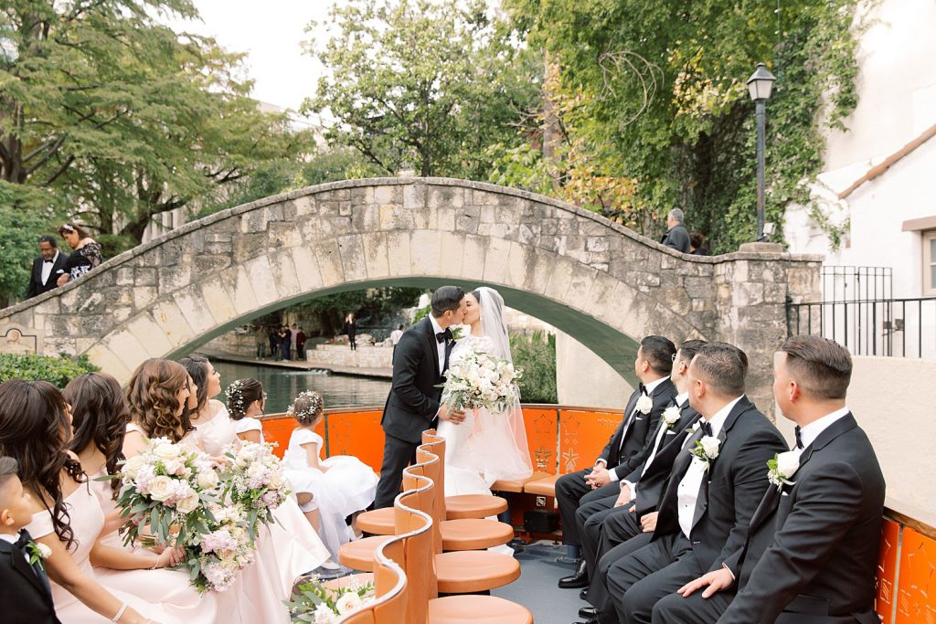bride and groom kiss under the Selena bridge for a wedding at the Jack Guenther Pavilion at the Briscoe in San Antonio with Monica Roberts Photography - https://monicaroberts.com/