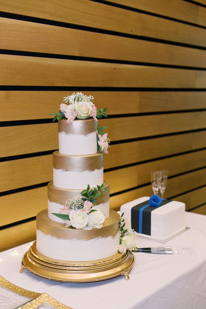 white and gold with blush wedding cake for a wedding at the Jack Guenther Pavilion at the Briscoe in San Antonio with Monica Roberts Photography - https://monicaroberts.com/