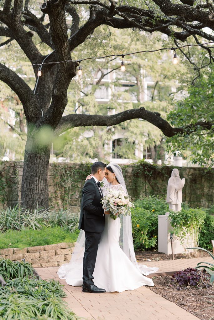 bride and groom standing forehead to forehead for a portraits for a wedding at the Jack Guenther Pavilion at the Briscoe in San Antonio with Monica Roberts Photography - https://monicaroberts.com/
