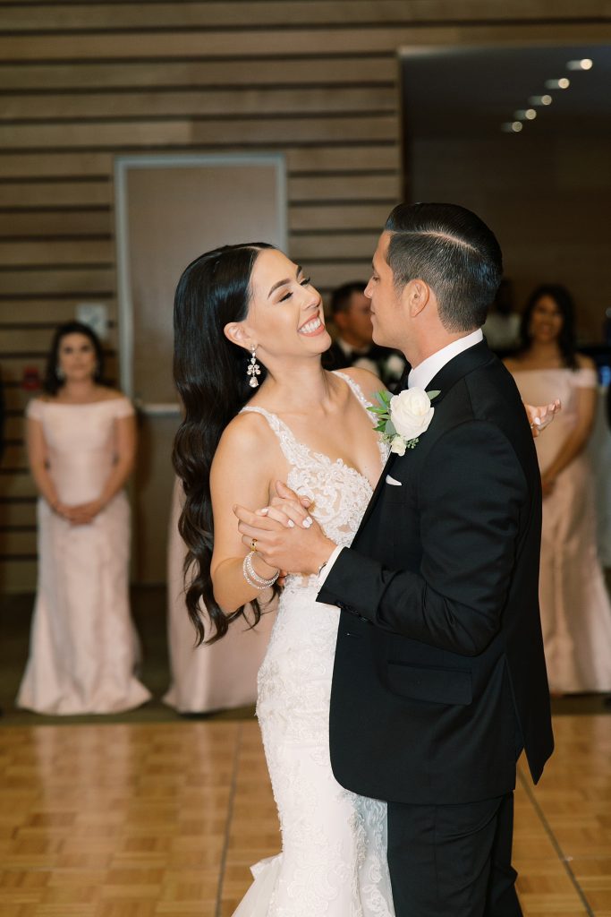 bride and groom smiling and looking at each other for their first dance for a wedding at the Jack Guenther Pavilion at the Briscoe in San Antonio with Monica Roberts Photography - https://monicaroberts.com/