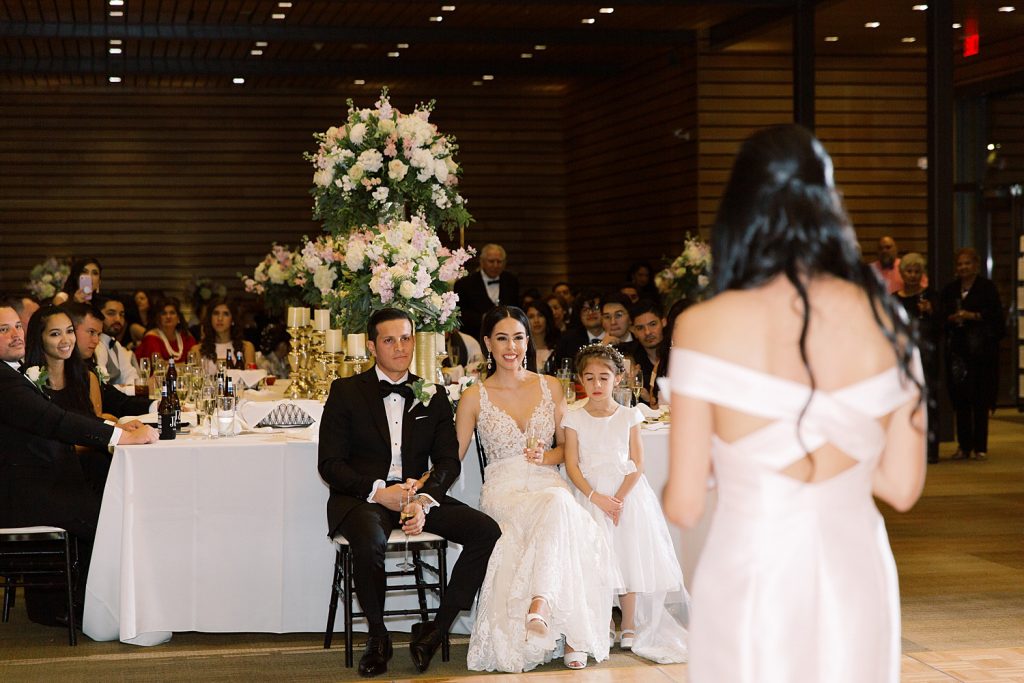 maid of honor gives speech while couple looks on for a wedding at the Jack Guenther Pavilion at the Briscoe in San Antonio with Monica Roberts Photography - https://monicaroberts.com/