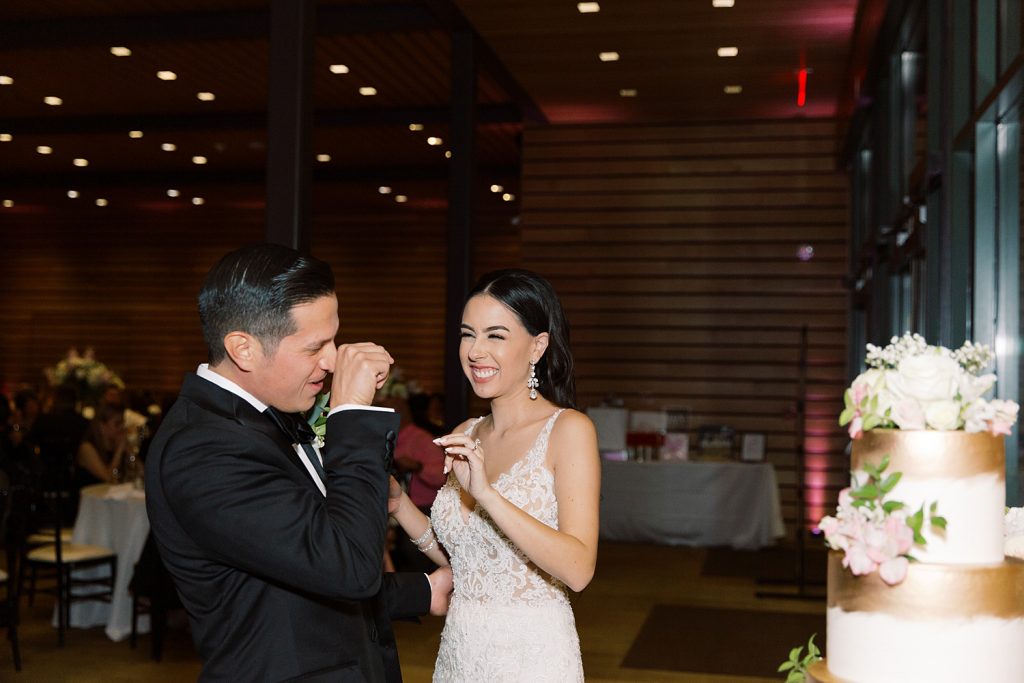 bride puts icing on grooms nose for a wedding at the Jack Guenther Pavilion at the Briscoe in San Antonio with Monica Roberts Photography - https://monicaroberts.com/