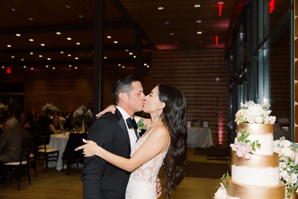 couple shares a kiss for a wedding at the Jack Guenther Pavilion at the Briscoe in San Antonio with Monica Roberts Photography - https://monicaroberts.com/