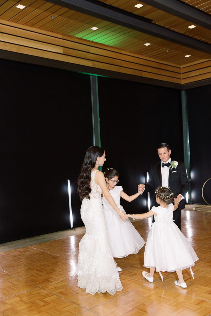 bride and groom dance with flower girls for a wedding at the Jack Guenther Pavilion at the Briscoe in San Antonio with Monica Roberts Photography - https://monicaroberts.com/