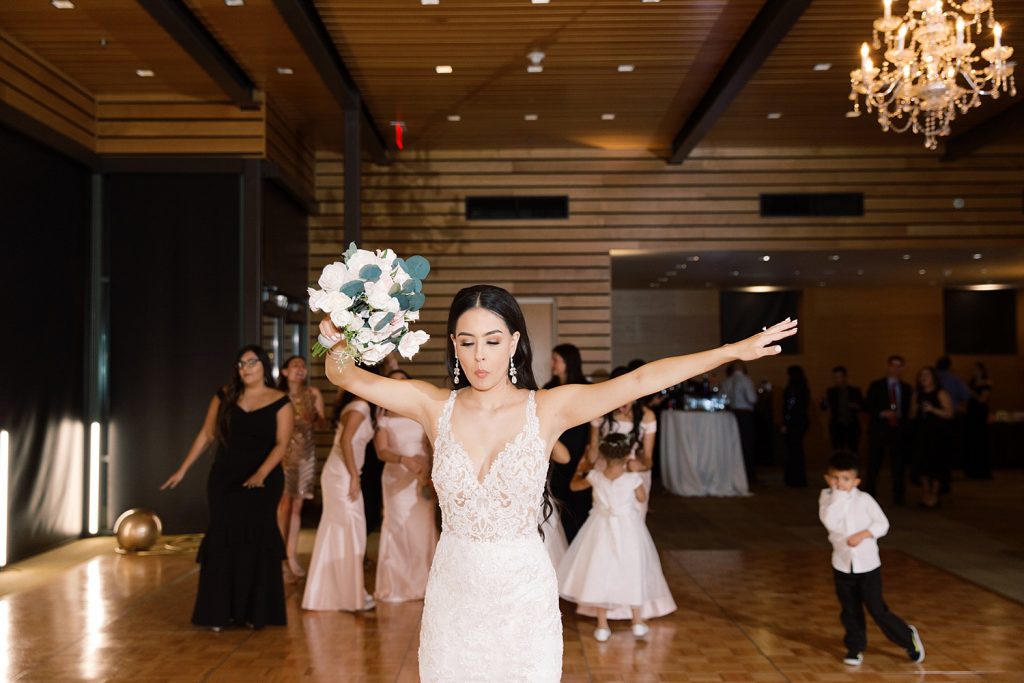 bouquet toss for a wedding at the Jack Guenther Pavilion at the Briscoe in San Antonio with Monica Roberts Photography - https://monicaroberts.com/