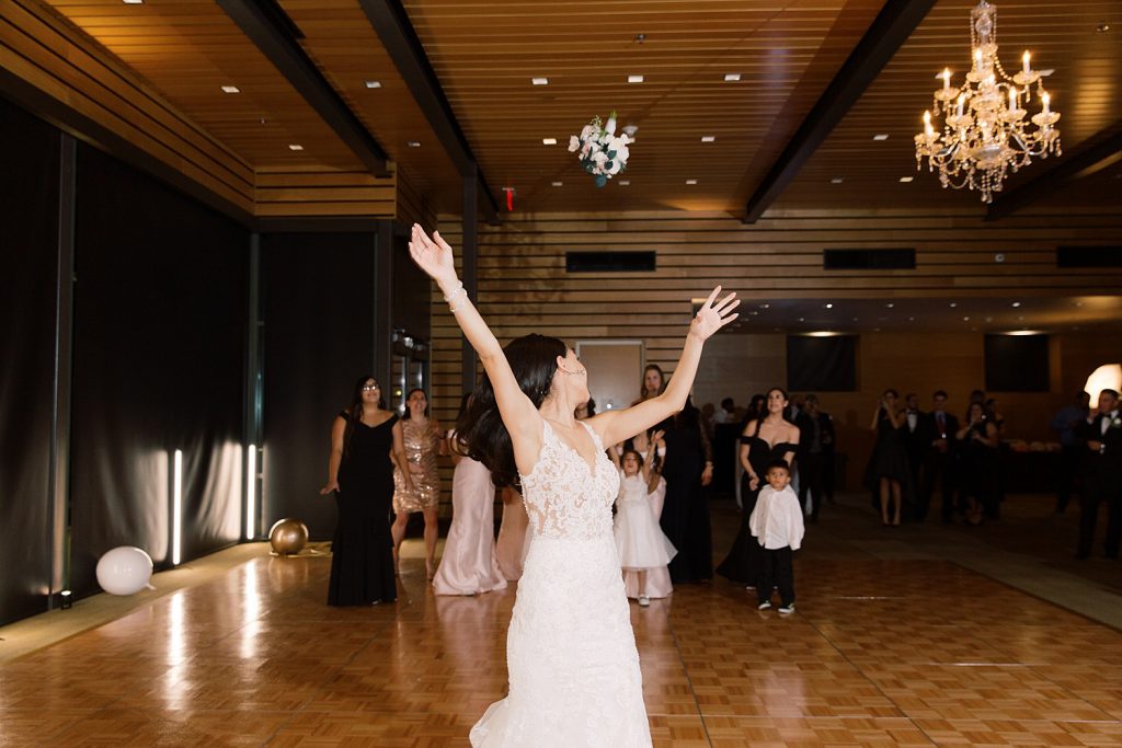 bride throws bouquet for a wedding at the Jack Guenther Pavilion at the Briscoe in San Antonio with Monica Roberts Photography - https://monicaroberts.com/