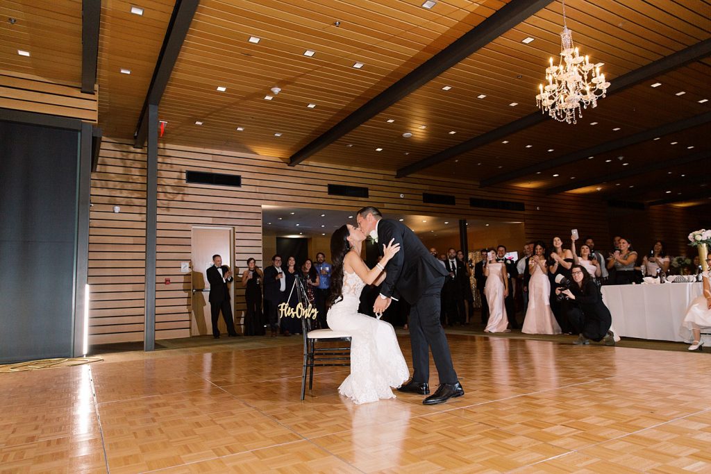 couples steals a kiss for a wedding at the Jack Guenther Pavilion at the Briscoe in San Antonio with Monica Roberts Photography - https://monicaroberts.com/