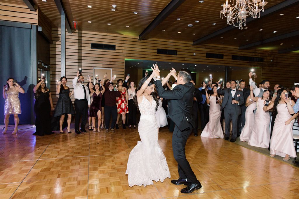 couple dances as crowd surrounds them for a wedding at the Jack Guenther Pavilion at the Briscoe in San Antonio with Monica Roberts Photography - https://monicaroberts.com/
