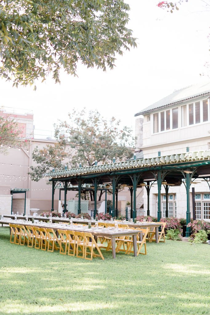 dinner table with venue in the background for a gorgeous outdoor garden wedding at The Guenther House in San Antonio, TX | Monica Roberts Photography | www.monicaroberts.com