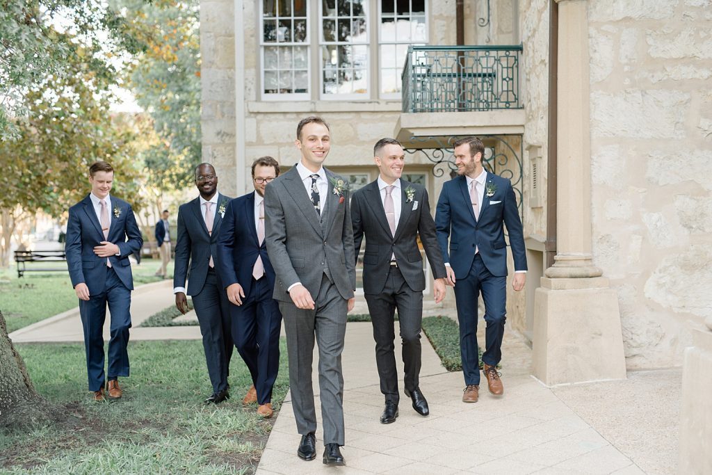 groom walking with his groomsmen for a gorgeous outdoor garden wedding at The Guenther House in San Antonio, TX | Monica Roberts Photography | www.monicaroberts.com