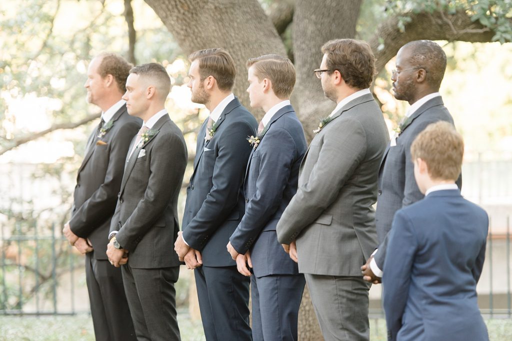 groomsmen watching couple gets married for a gorgeous outdoor garden wedding at The Guenther House in San Antonio, TX | Monica Roberts Photography | www.monicaroberts.com