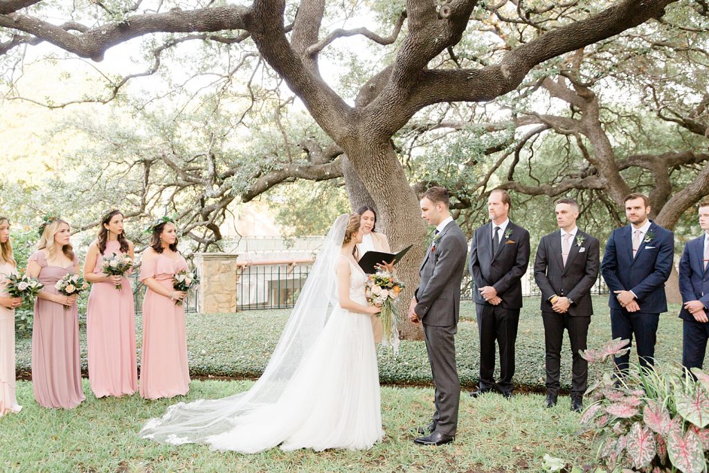 couple marries outside under a tree for a gorgeous outdoor garden wedding at The Guenther House in San Antonio, TX | Monica Roberts Photography | www.monicaroberts.com