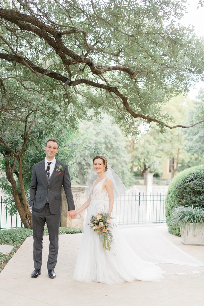 bride and groom standing up a tree for a gorgeous outdoor garden wedding at The Guenther House in San Antonio, TX | Monica Roberts Photography | www.monicaroberts.com
