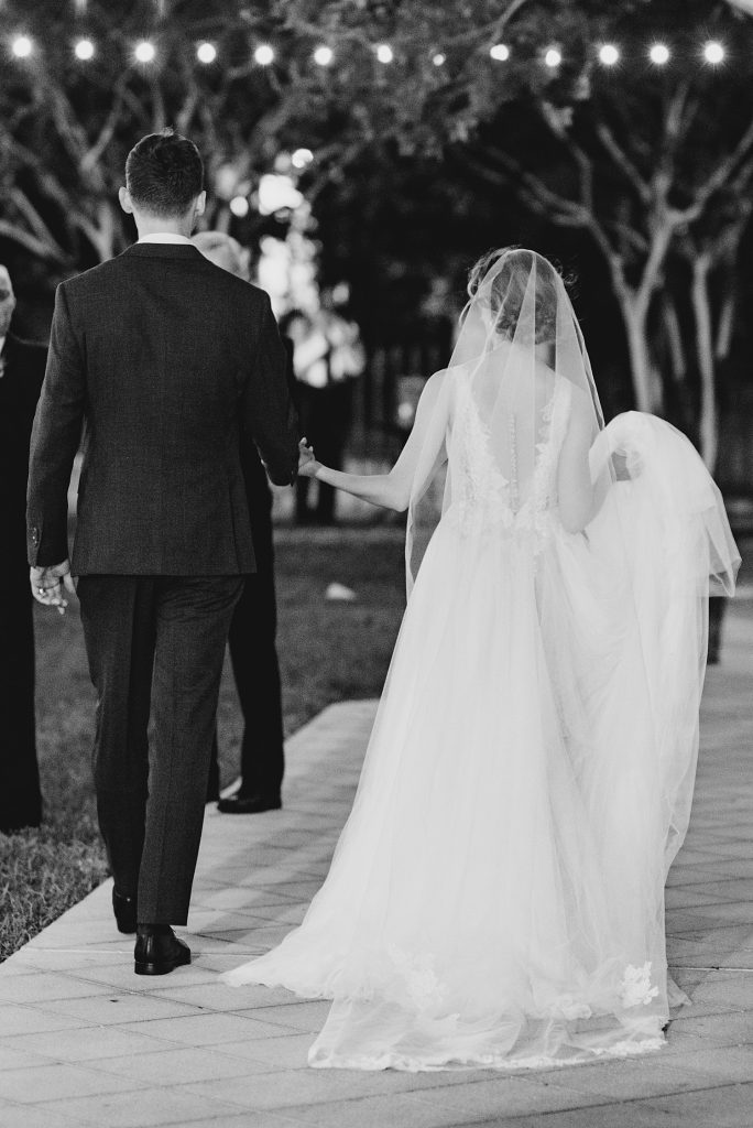 black and white images of bride and groom walking for a gorgeous outdoor garden wedding at The Guenther House in San Antonio, TX | Monica Roberts Photography | www.monicaroberts.com