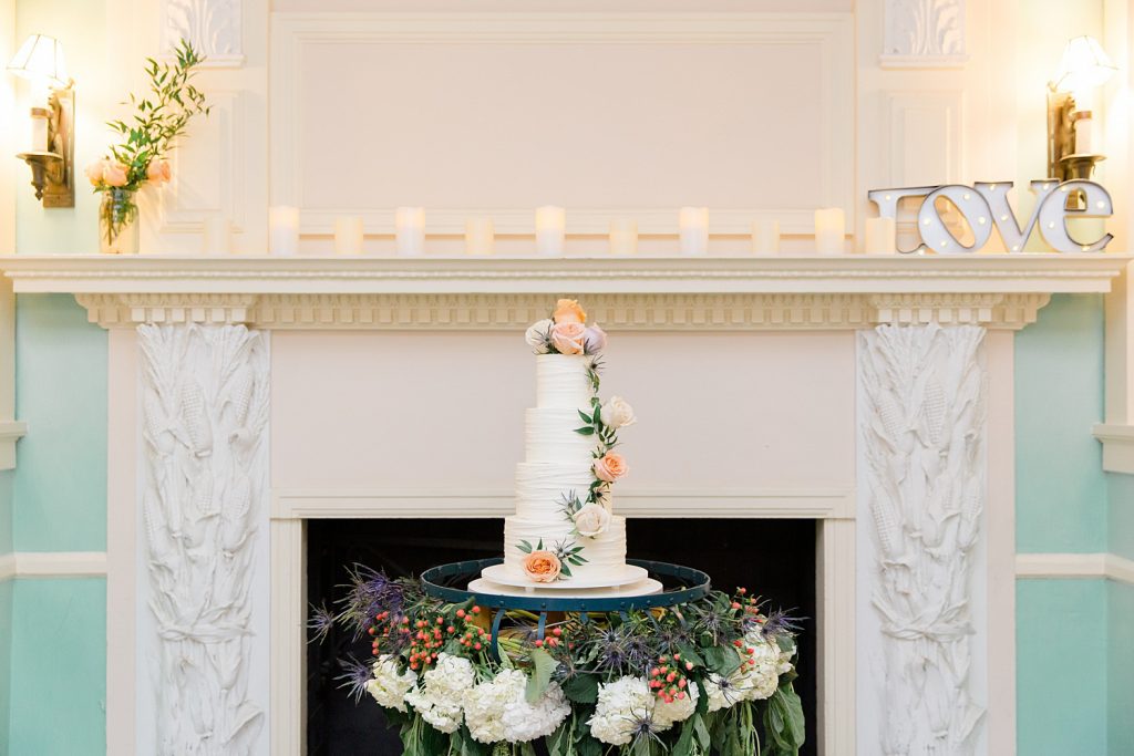 wedding cake in front of fireplace for a gorgeous outdoor garden wedding at The Guenther House in San Antonio, TX | Monica Roberts Photography | www.monicaroberts.com