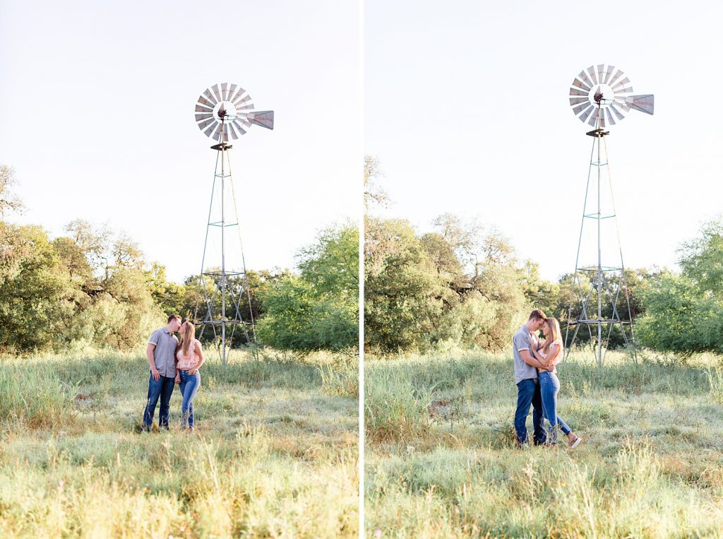 couple nuzzles in a field with a windtower in Downtown San Antonio for their engagement session with Monica Roberts Photography https://monicaroberts.com