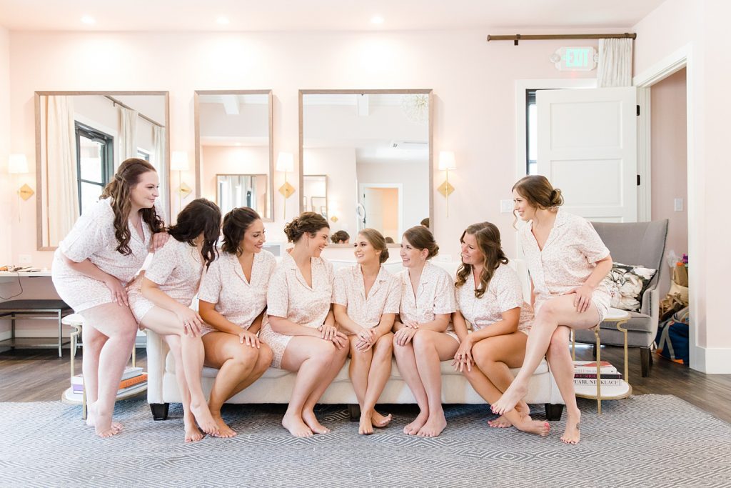 bride with her bridesmaids hanging out for a Romantic dusty rose wedding at Hayes Hollow with Monica Roberts Photography https://monicaroberts.com/