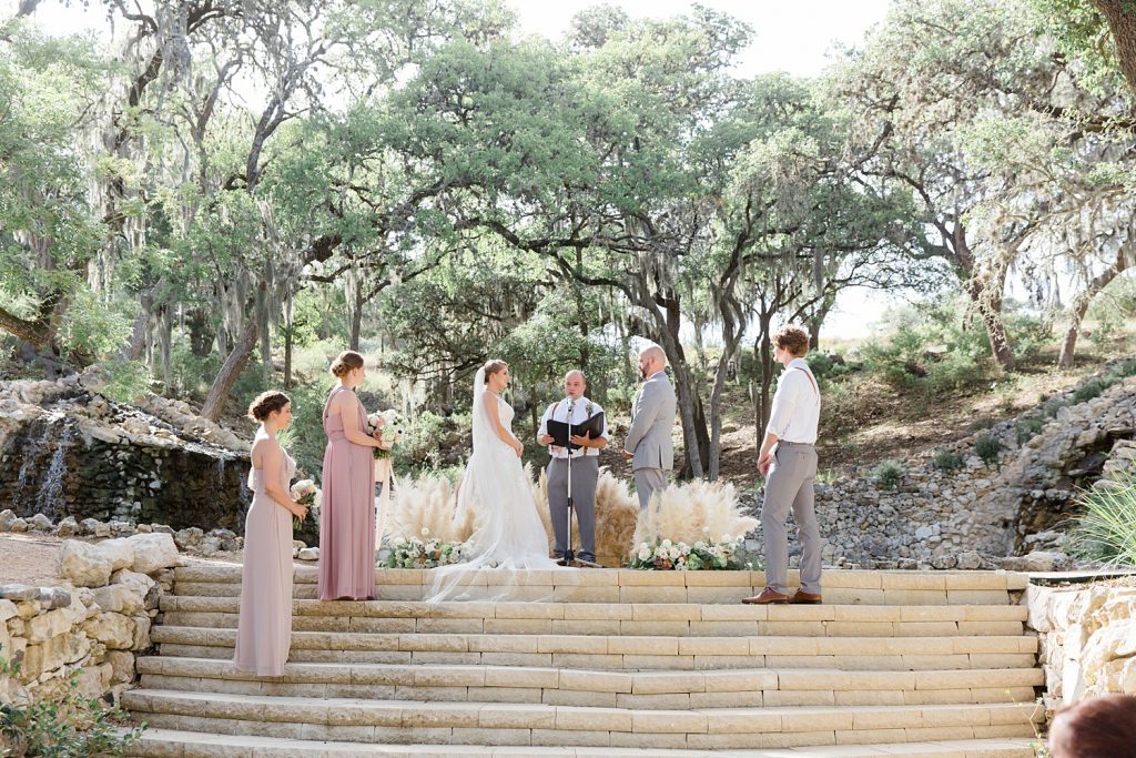 couple gets married under moss tress for a Romantic dusty rose wedding at Hayes Hollow with Monica Roberts Photography https://monicaroberts.com/