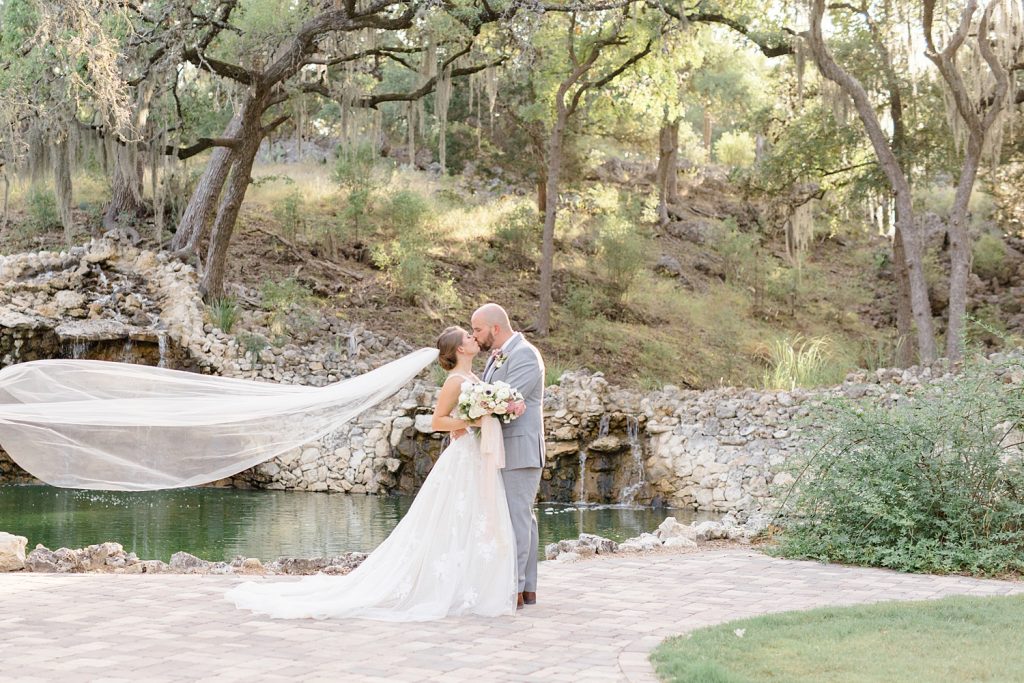 brides veil blowing in the wind for a Romantic dusty rose wedding at Hayes Hollow with Monica Roberts Photography https://monicaroberts.com/