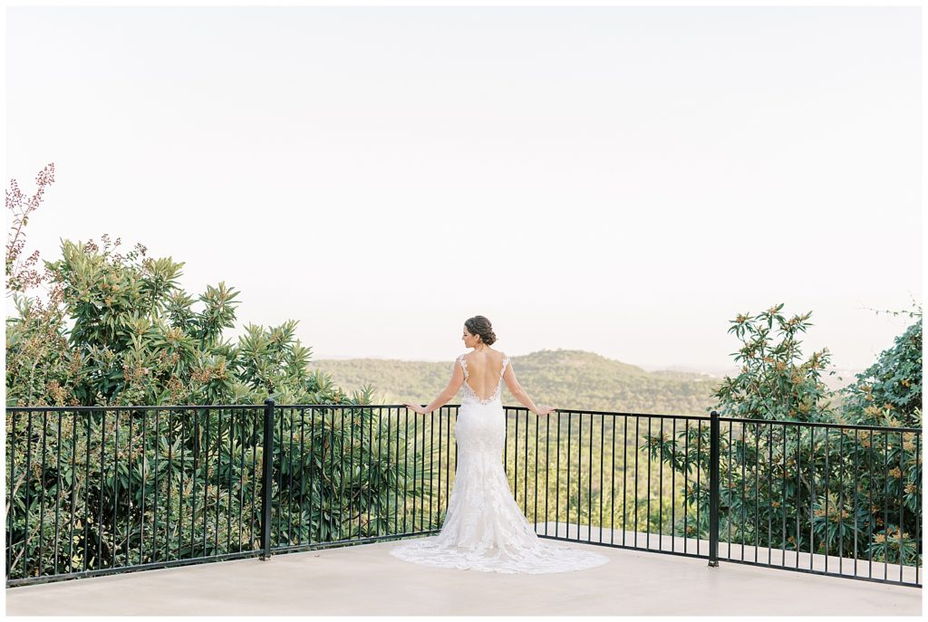 Bride standing showing off the back of her dress for her Bridals at Villa Antonia in Austin, TX for Monica Roberts Photography Wedding Photographer in Austin, TX
