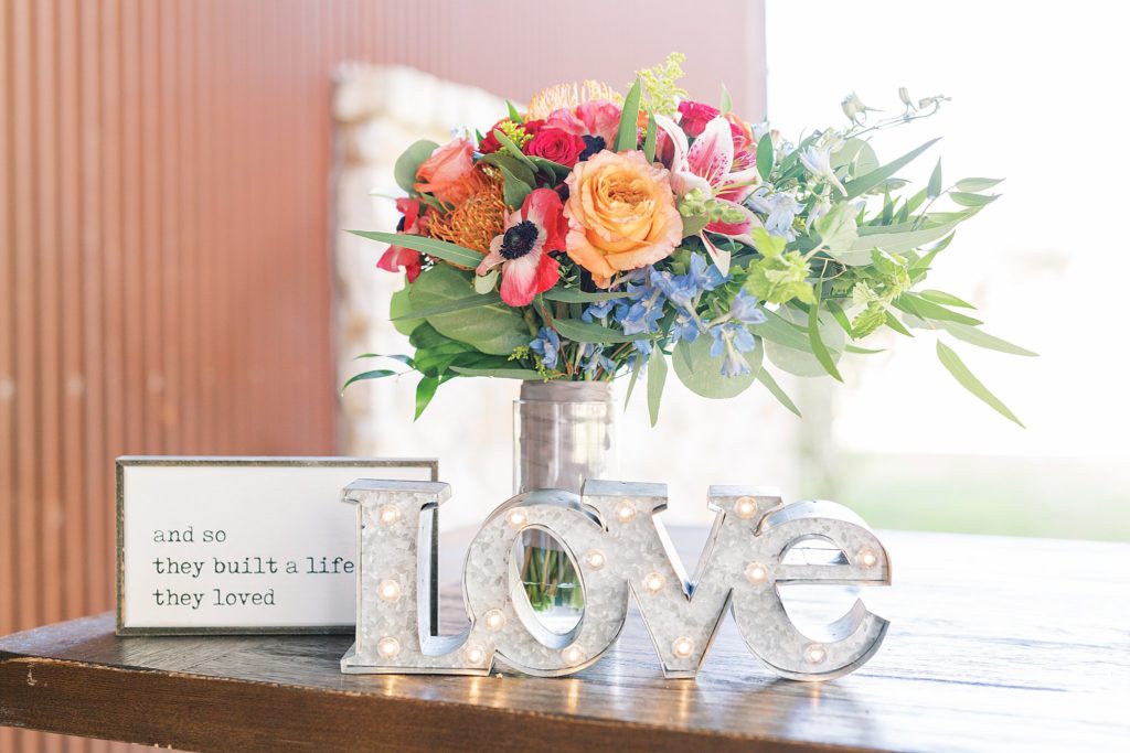 love sign with flowers for A Colorful and Fun Wedding at Western Sky in San Antonio, TX with Monica Roberts Photography www.monicaroberts.com