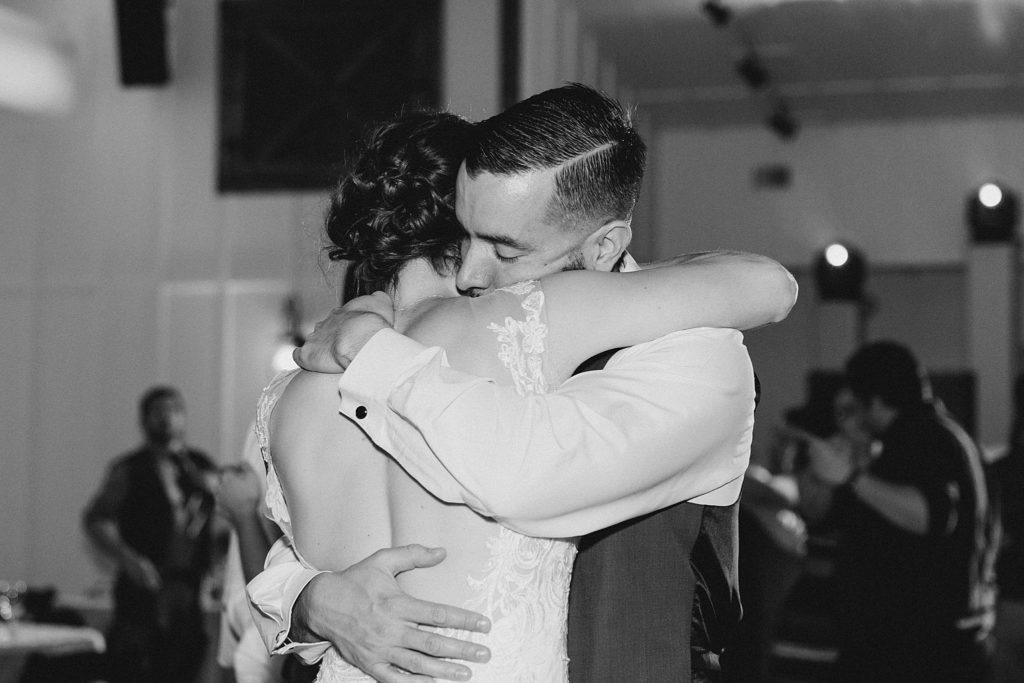 black and white of bride and groom hugging for A Colorful and Fun Wedding at Western Sky in San Antonio, TX with Monica Roberts Photography www.monicaroberts.com