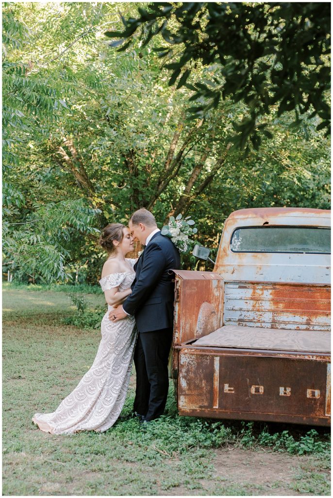 Bride and Groom leaning towards each other while standing next to a vintage ford pickup truck for their Downtown Washington D.C. Wedding romantic wedding at the sekrit theatre in Austin, TX by Monica Roberts Photography Wedding Photographer in Washington D.C.