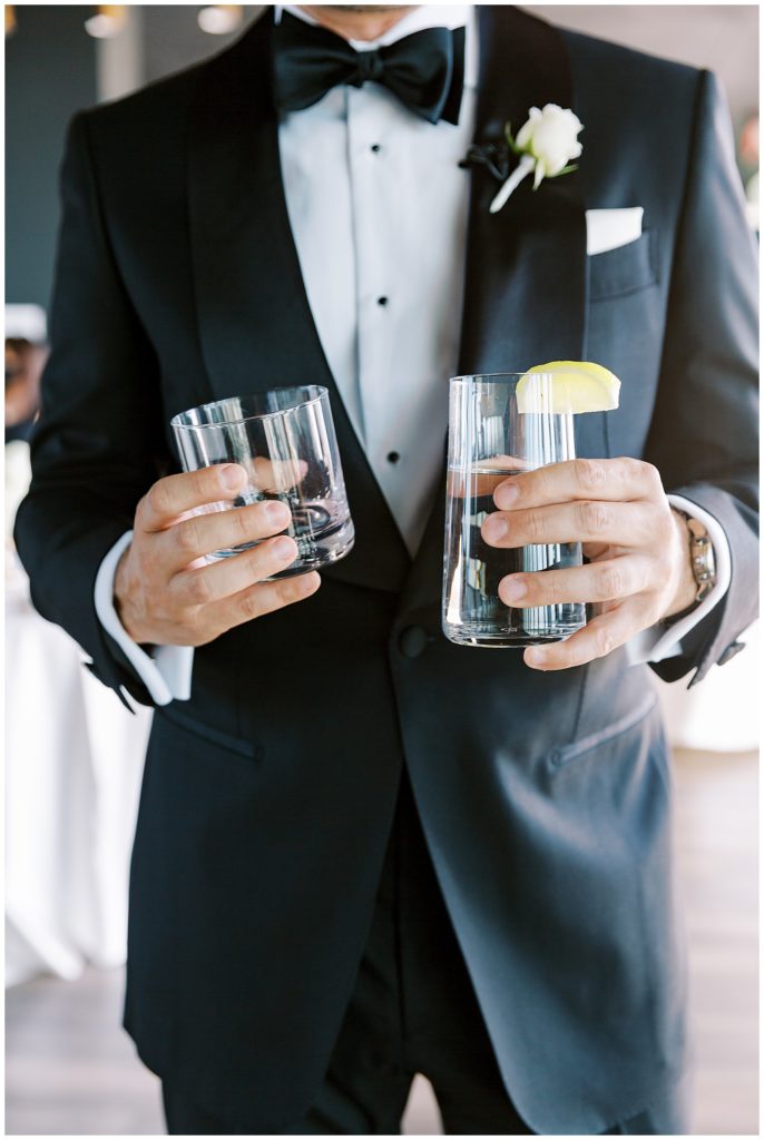 groom holding a drink before his first look for a romantic wedding at the Thompson Hotel in Richmond Virginia with Monica Roberts Photography monicaroberts.com 