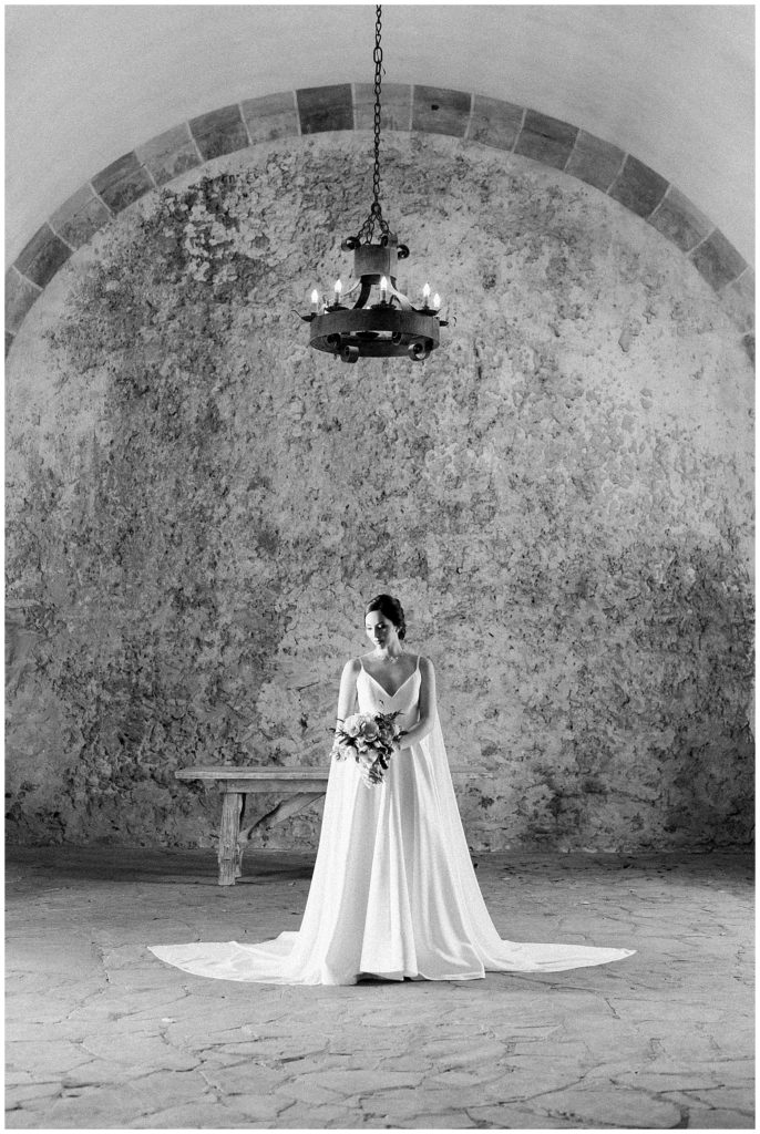 black and white image of briding standing under lights for her bridals in Richmond, Virginia