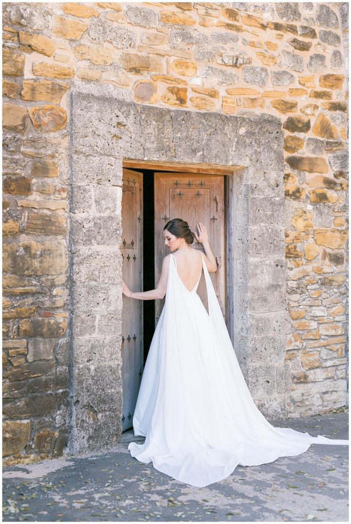 bride looking down as she holds the door for her bridals in Richmond, Virginia